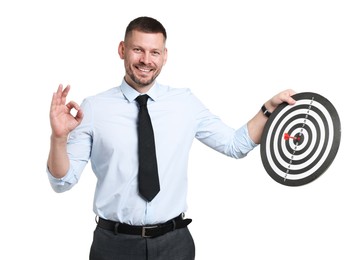 Photo of Targeting. Man with dart board and arrow showing ok gesture on white background