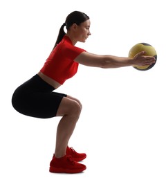 Photo of Athletic woman exercising with medicine ball on white background