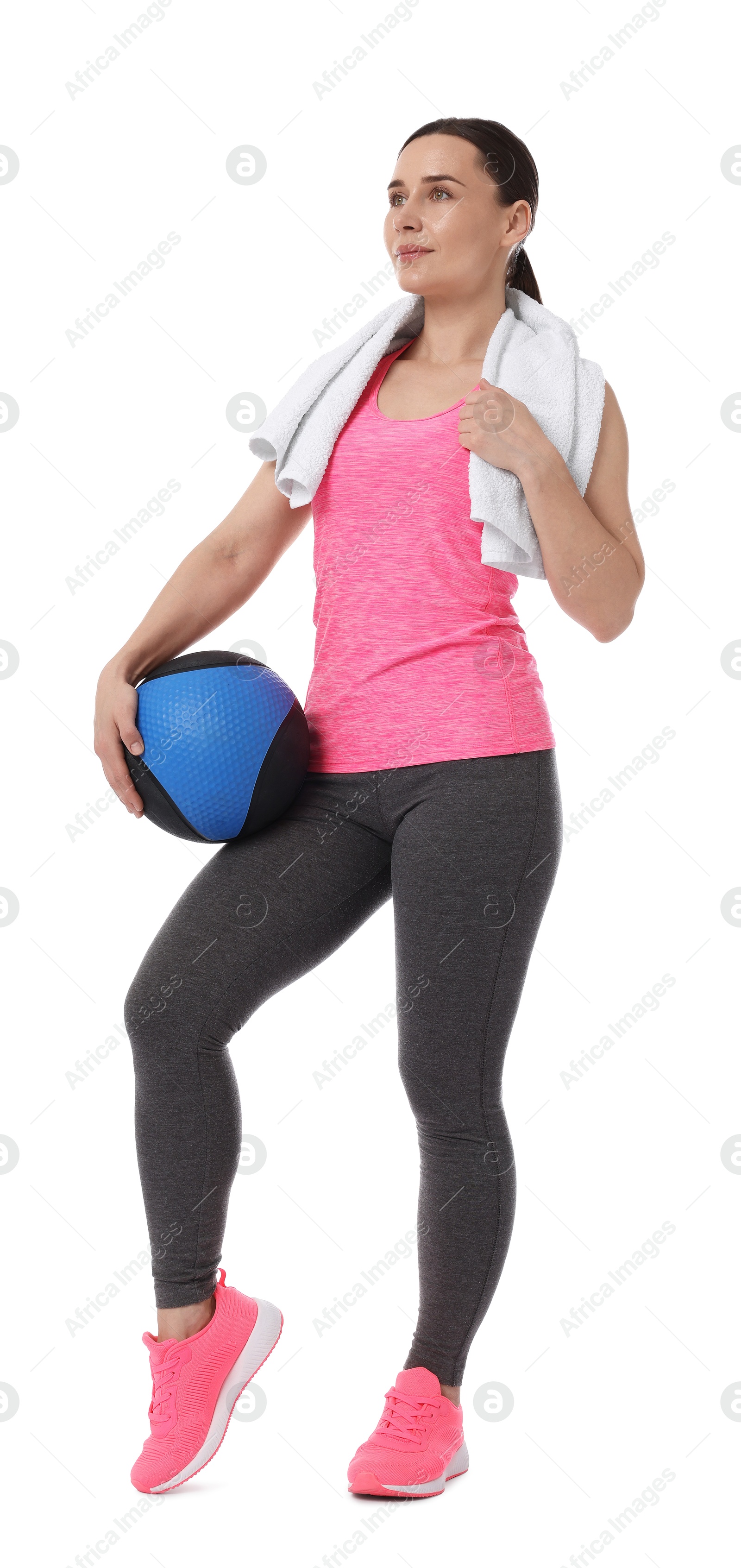 Woman with medicine ball and towel on white background Photo of Woman with medicine ball and towel on white background