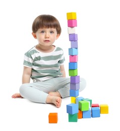 Photo of Cute little child playing with colorful cubes on white background