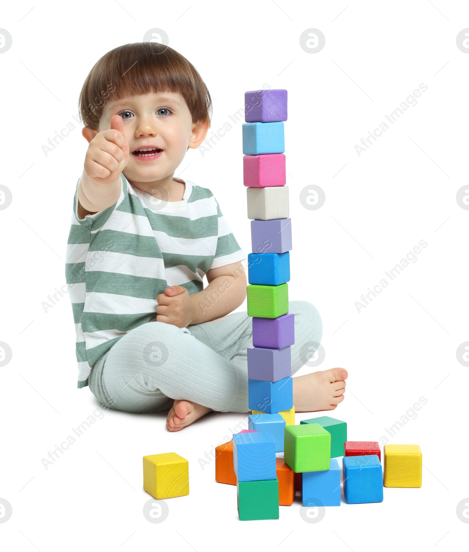 Cute little child playing with colorful cubes on white background Photo of Cute little child playing with colorful cubes on white background