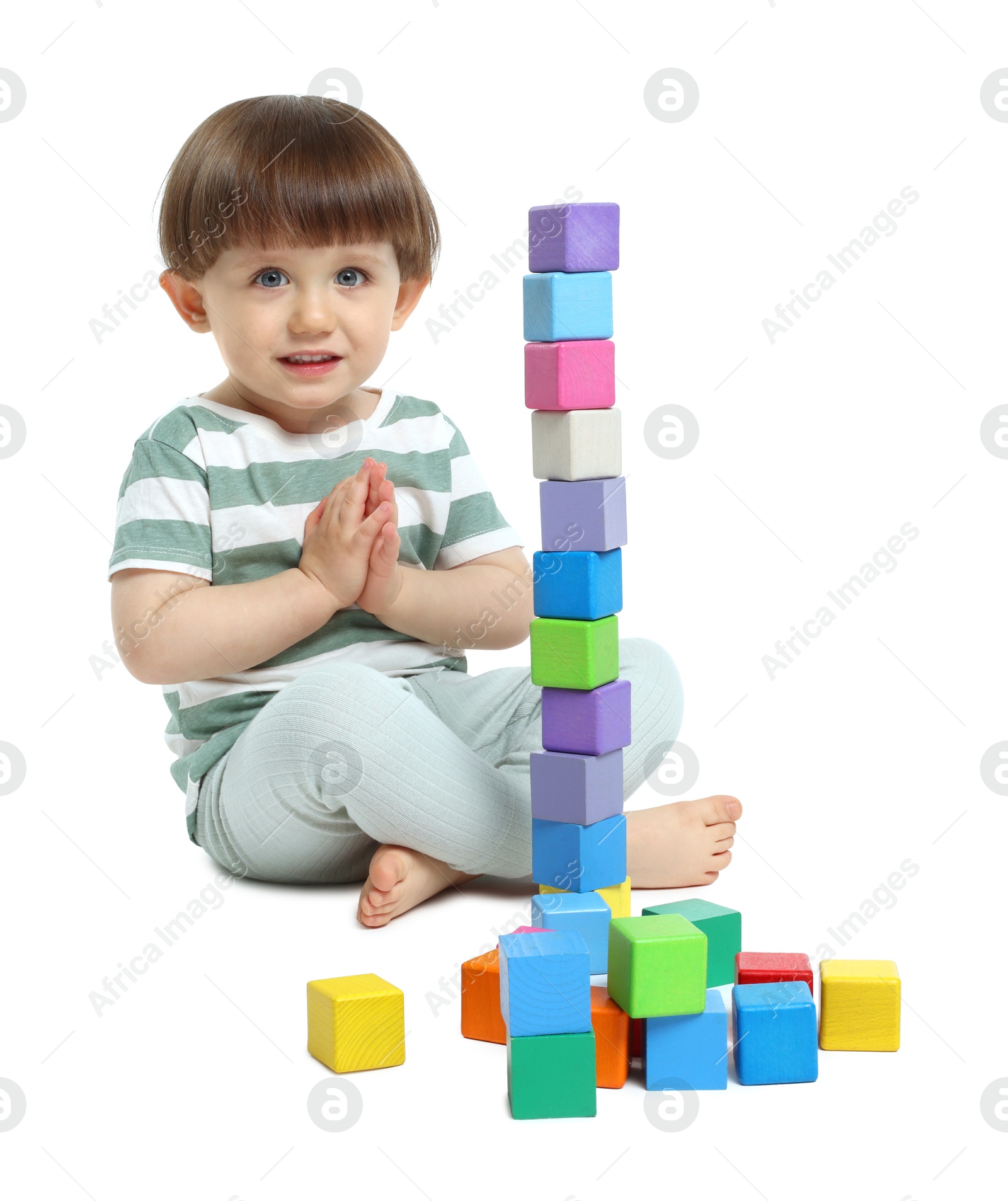 Cute little child playing with colorful cubes on white background Photo of Cute little child playing with colorful cubes on white background