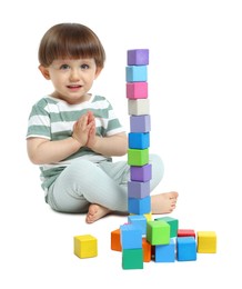 Photo of Cute little child playing with colorful cubes on white background