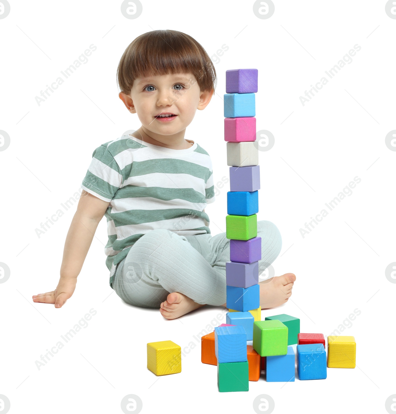 Cute little child playing with colorful cubes on white background Photo of Cute little child playing with colorful cubes on white background