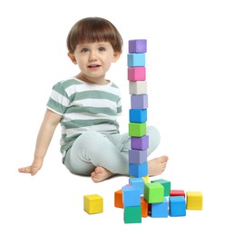 Photo of Cute little child playing with colorful cubes on white background