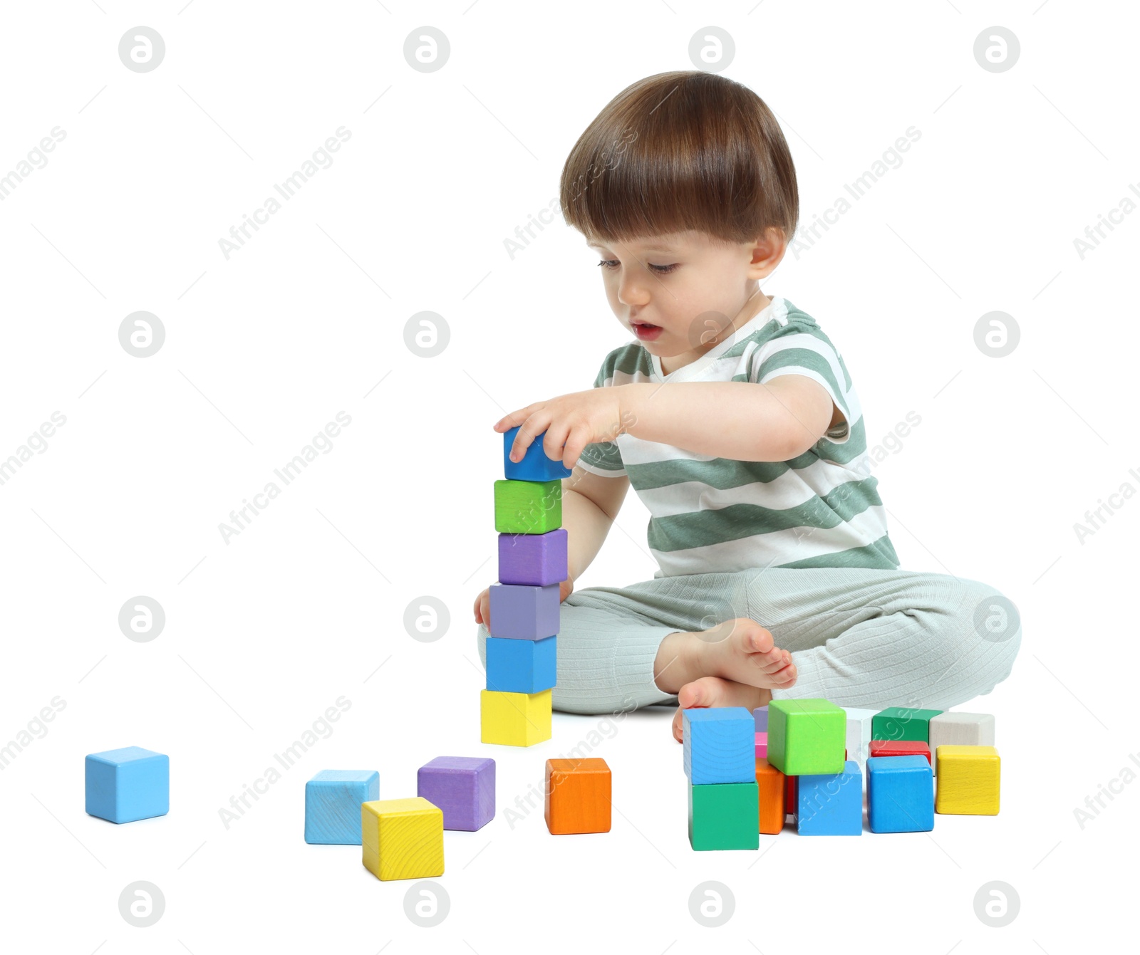 Cute little child playing with colorful cubes on white background Photo of Cute little child playing with colorful cubes on white background