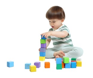 Photo of Cute little child playing with colorful cubes on white background