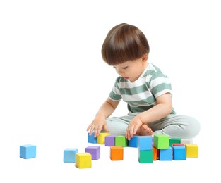 Photo of Cute little child playing with colorful cubes on white background