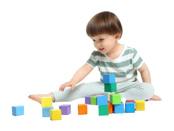 Photo of Cute little child playing with colorful cubes on white background