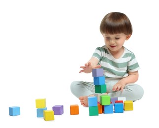Photo of Cute little child playing with colorful cubes on white background