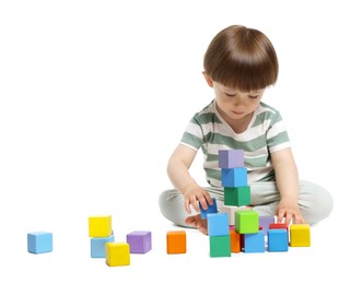 Photo of Cute little child playing with colorful cubes on white background