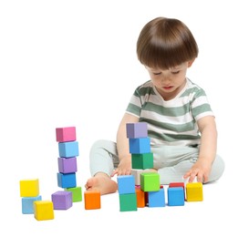Photo of Cute little child playing with colorful cubes on white background