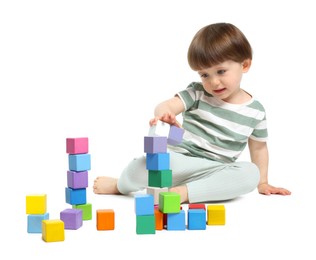 Photo of Cute little child playing with colorful cubes on white background
