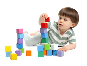 Photo of Cute little child playing with colorful cubes on white background
