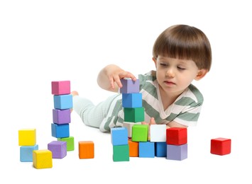 Photo of Cute little child playing with colorful cubes on white background