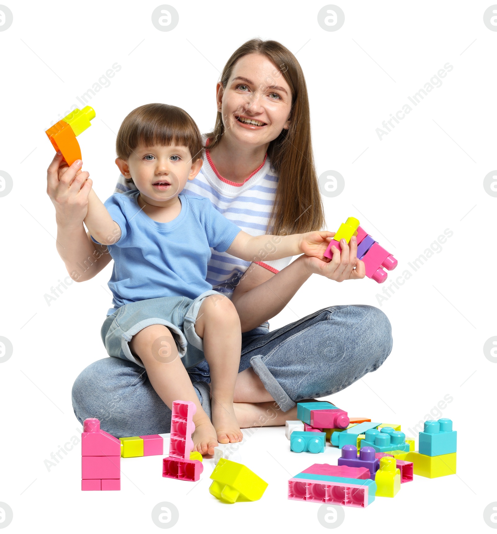 Mother and son playing with building bricks on white background Photo of Mother and son playing with building bricks on white background