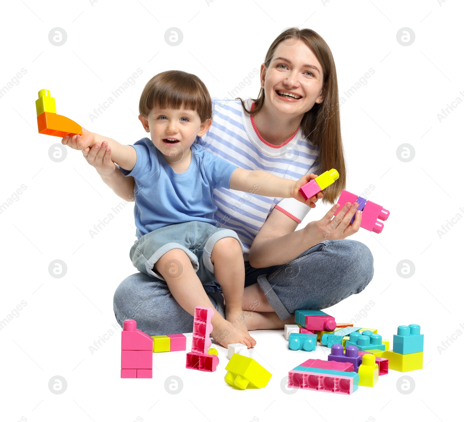 Mother and son playing with building bricks on white background Photo of Mother and son playing with building bricks on white background