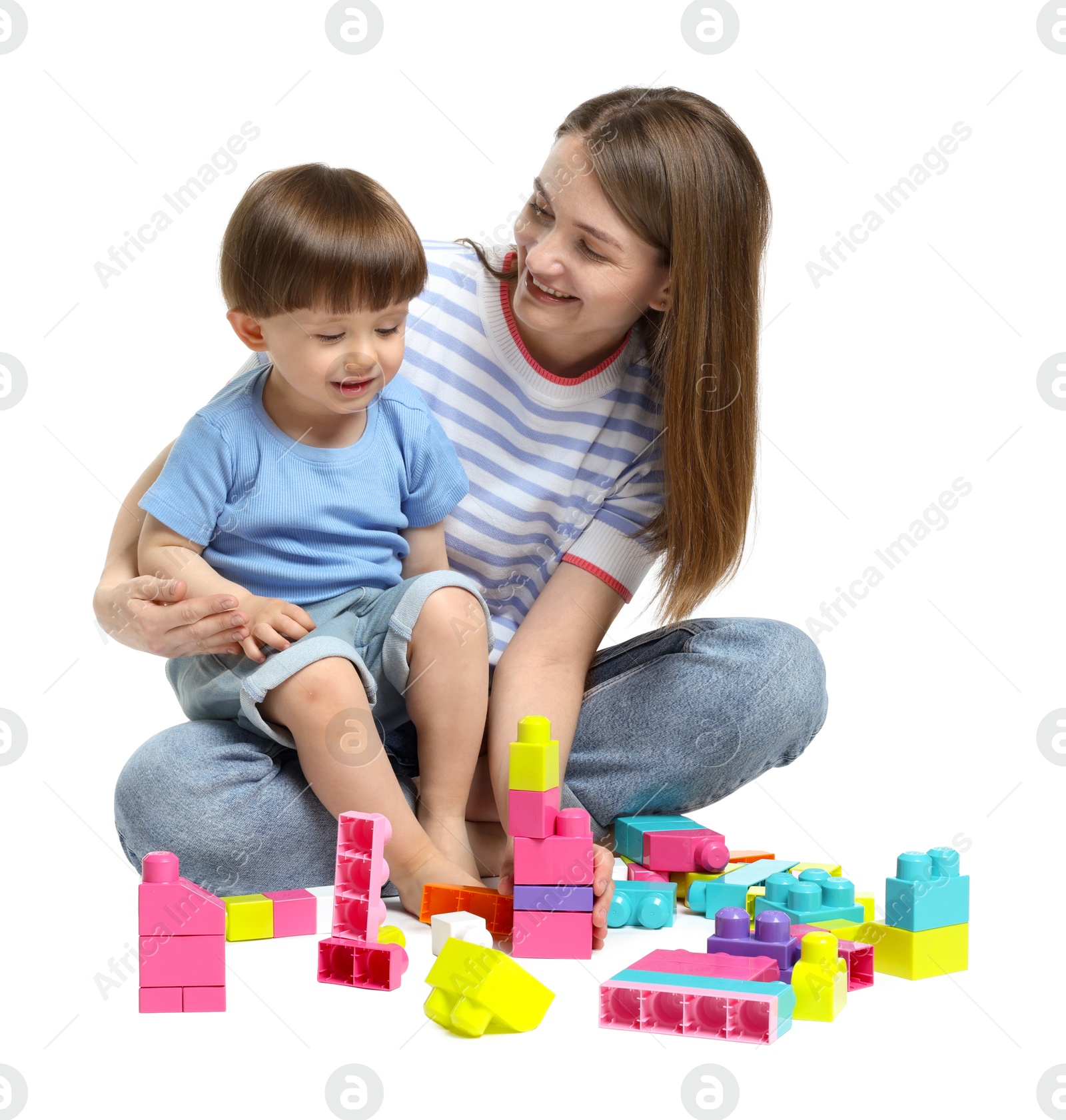 Mother and son playing with building bricks on white background Photo of Mother and son playing with building bricks on white background
