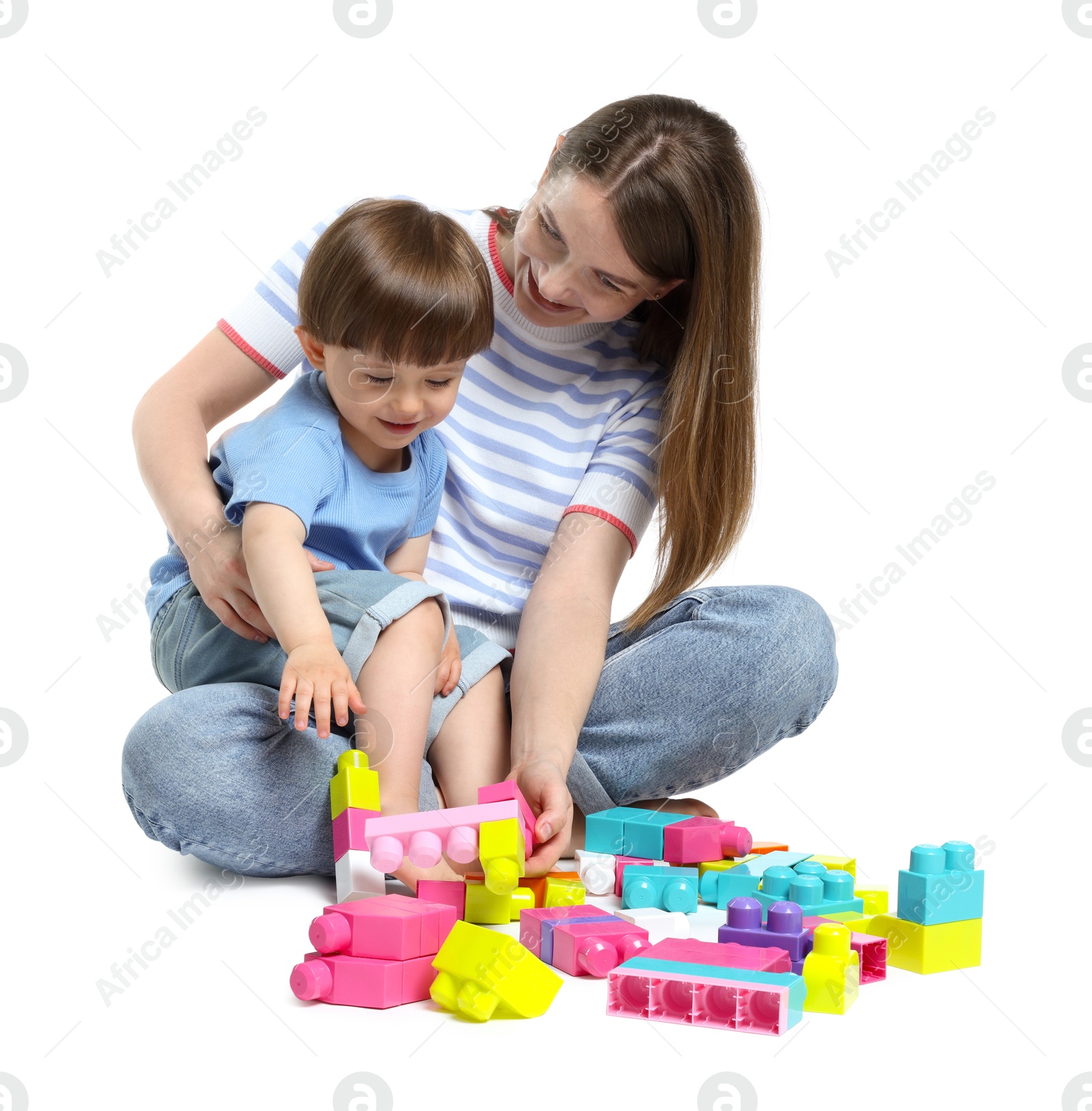 Mother and son playing with building bricks on white background Photo of Mother and son playing with building bricks on white background