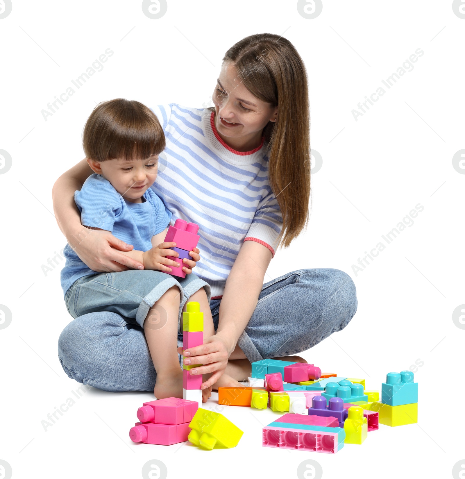 Mother and son playing with building bricks on white background Photo of Mother and son playing with building bricks on white background