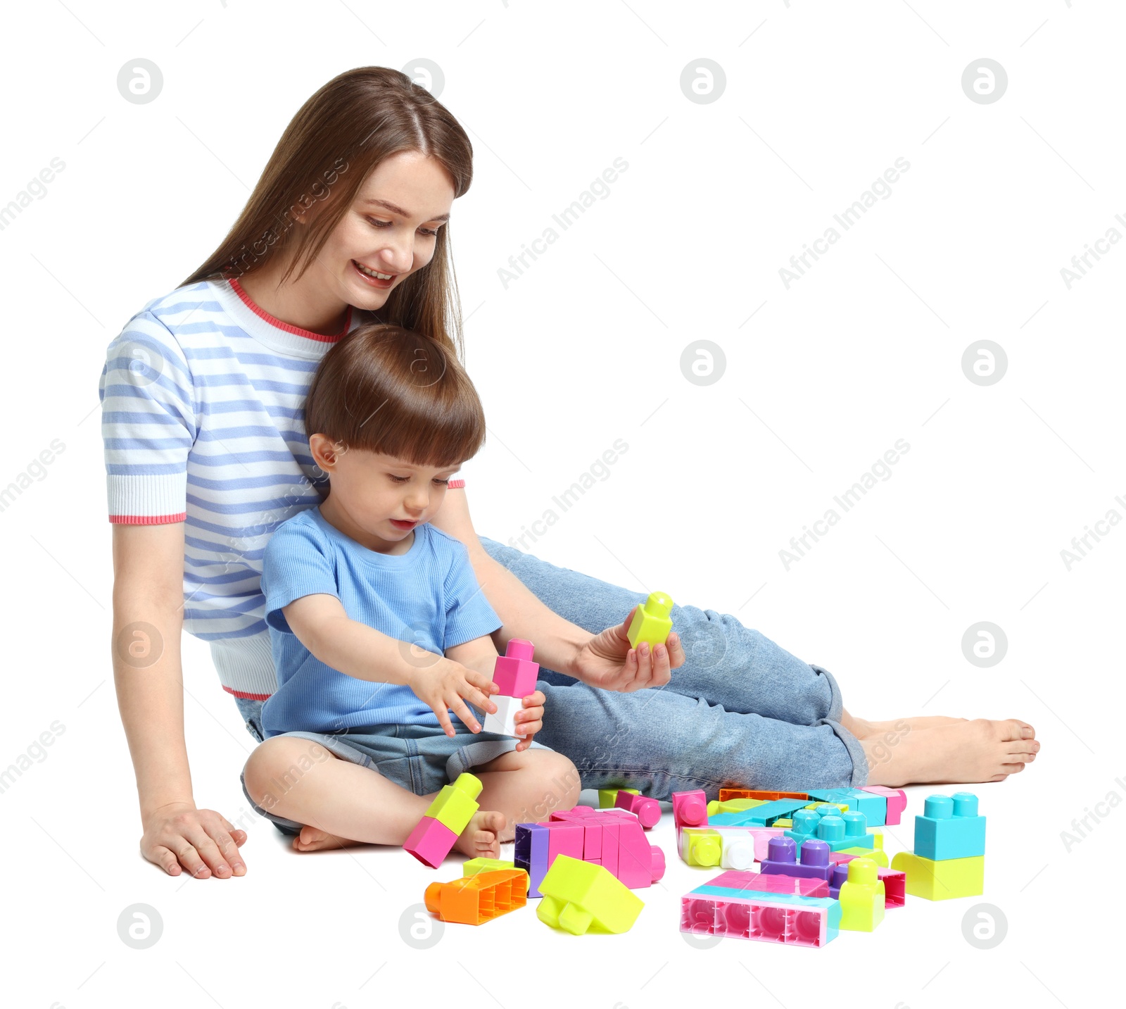 Mother and son playing with building bricks on white background Photo of Mother and son playing with building bricks on white background