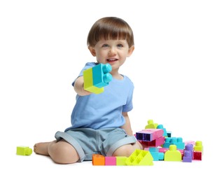 Photo of Cute little boy playing with building bricks on white background