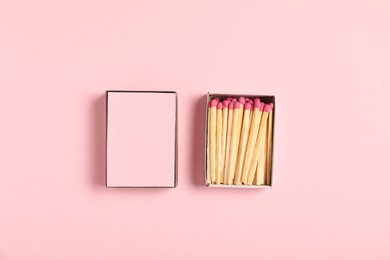 Photo of Matches and box on pink background, flat lay. Mockup for design