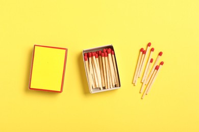 Photo of Matches and box on yellow background, flat lay. Mockup for design