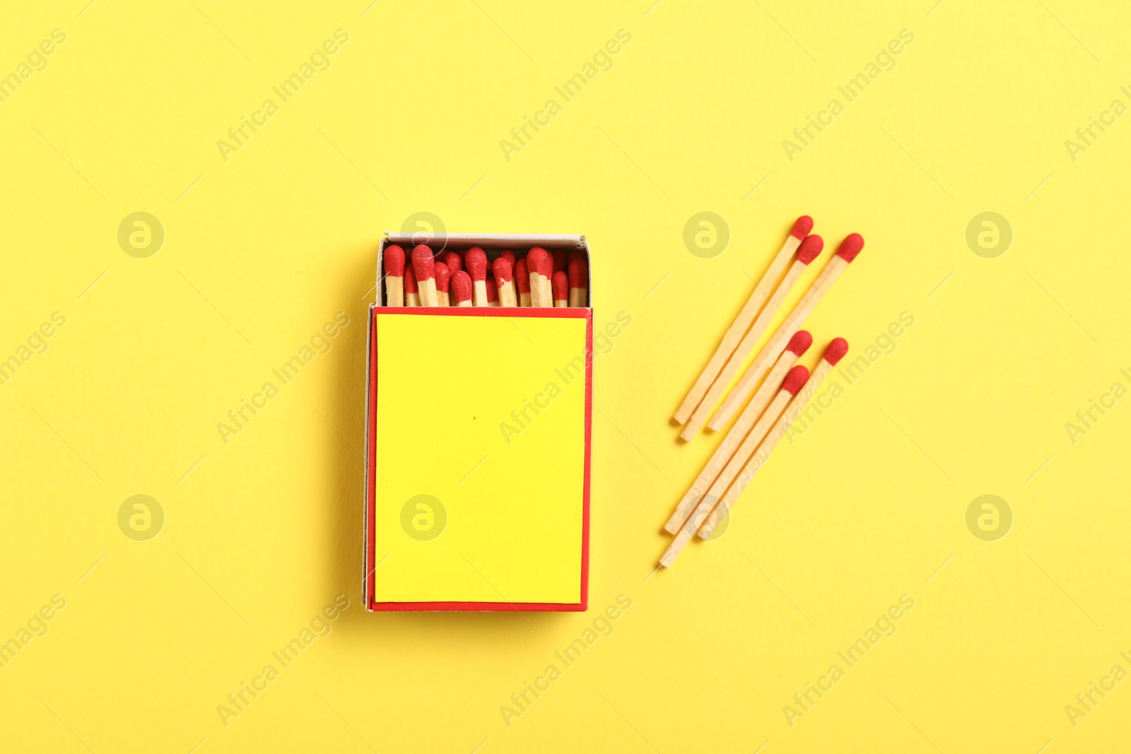 Matches and box on yellow background, flat lay. Mockup for design Photo of Matches and box on yellow background, flat lay. Mockup for design