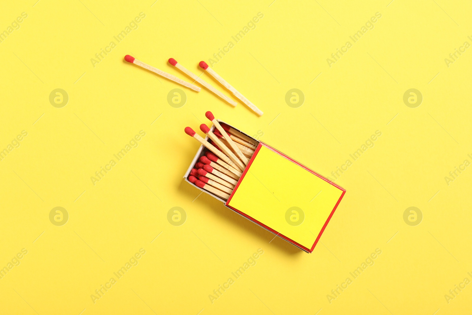 Matches and box on yellow background, flat lay. Mockup for design Photo of Matches and box on yellow background, flat lay. Mockup for design