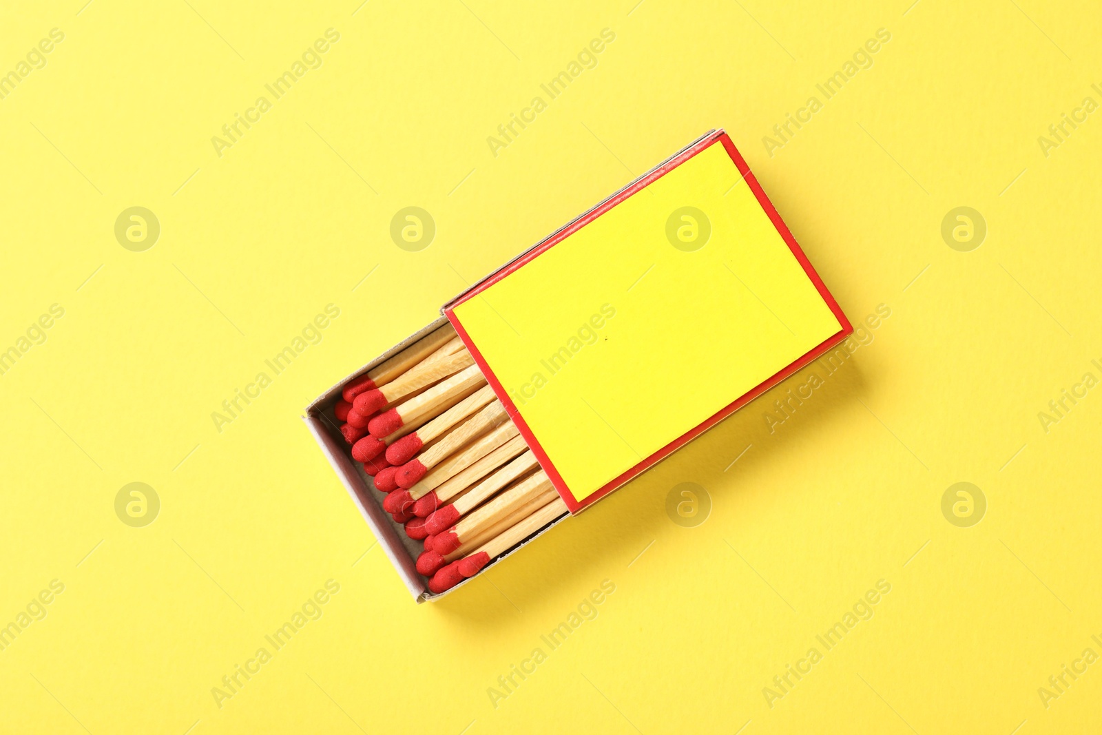 Matches in box on yellow background, top view. Mockup for design Photo of Matches in box on yellow background, top view. Mockup for design