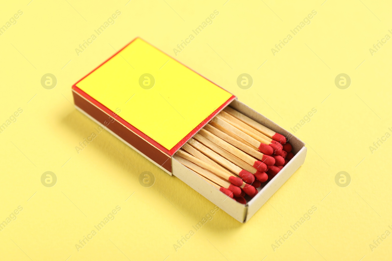 Matches in box on yellow background, closeup. Mockup for design Photo of Matches in box on yellow background, closeup. Mockup for design