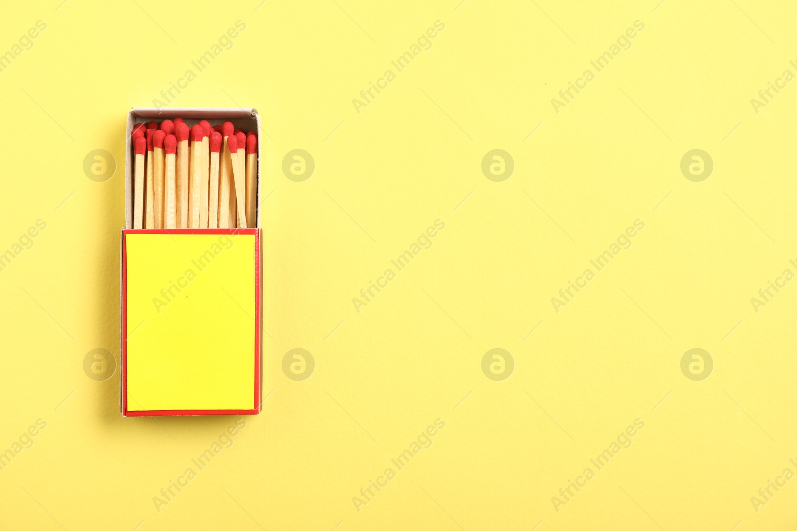 Matches in box on yellow background, top view. Mockup for design Photo of Matches in box on yellow background, top view. Mockup for design