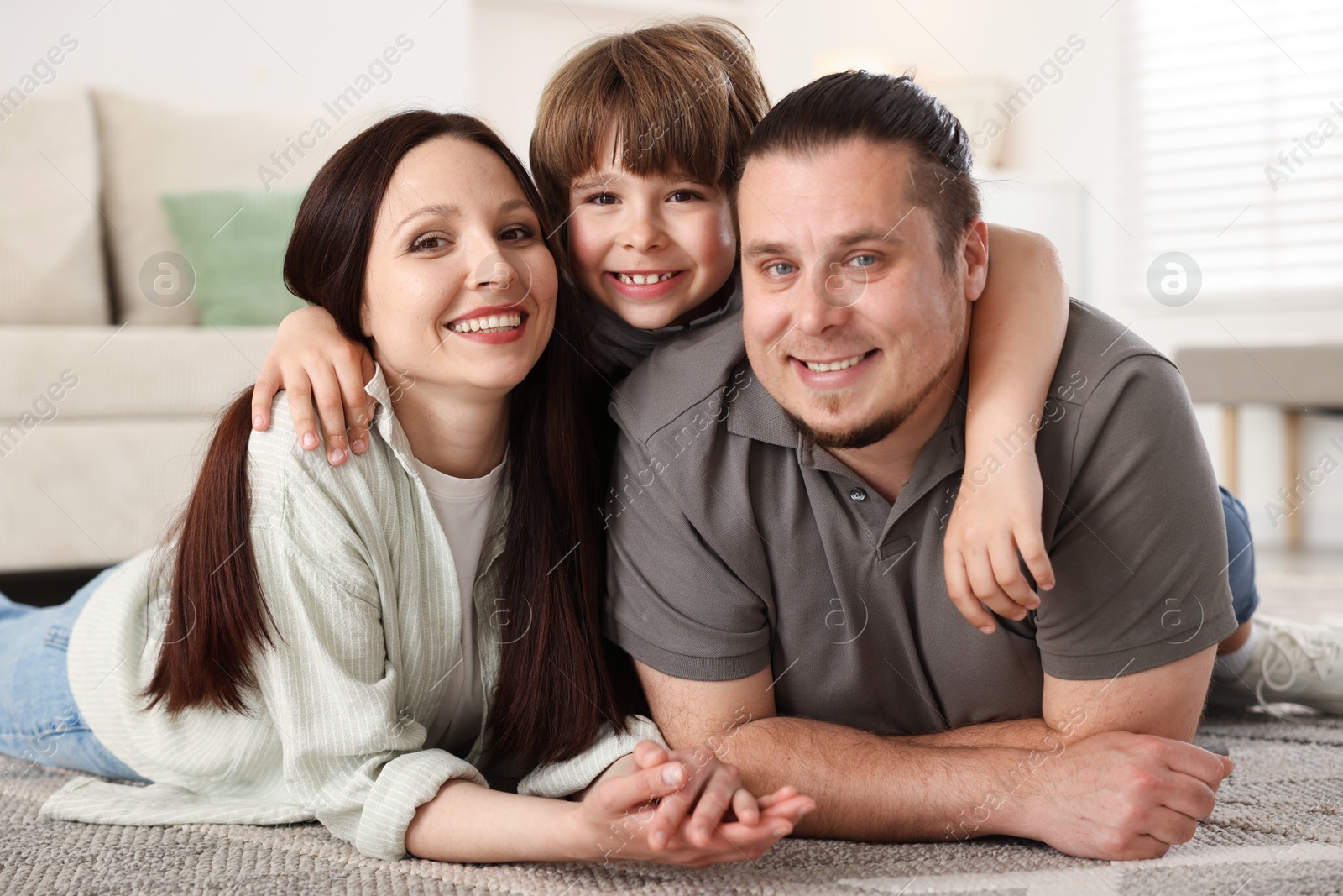 Parents with their son on floor at home Photo of Parents with their son on floor at home