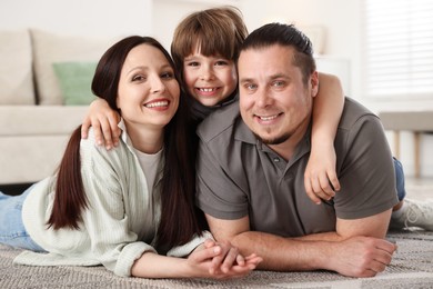 Photo of Parents with their son on floor at home