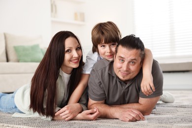 Photo of Parents with their son on floor at home