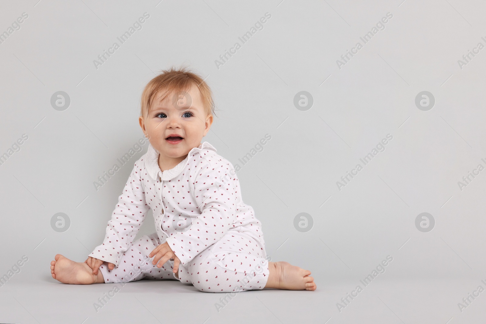 Cute little baby on light grey background, space for text Photo of Cute little baby on light grey background, space for text