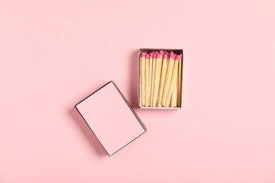 Photo of Matches and box on pink background, flat lay. Mockup for design