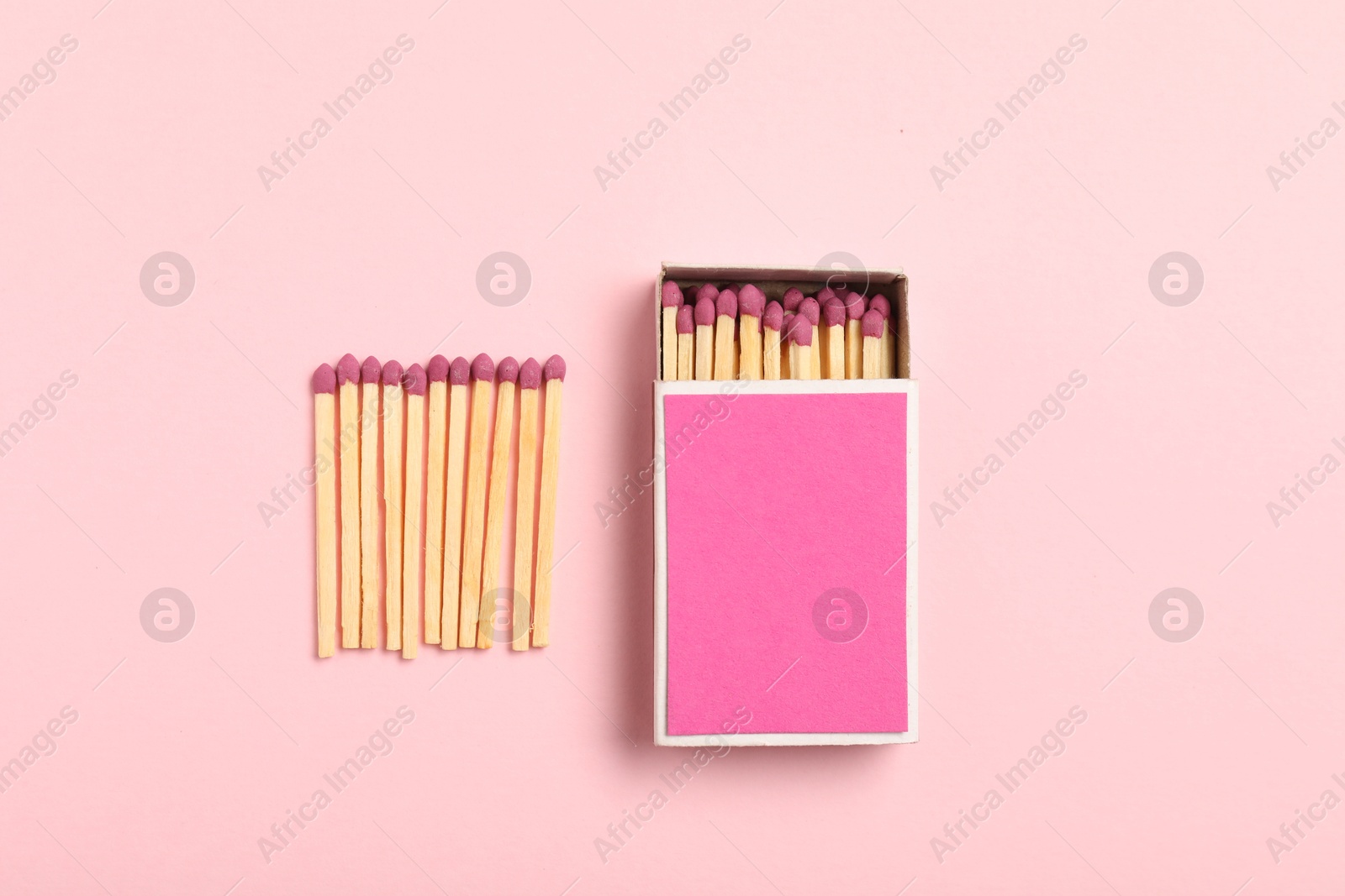 Matches and box on pink background, flat lay. Mockup for design Photo of Matches and box on pink background, flat lay. Mockup for design