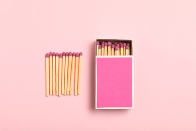 Photo of Matches and box on pink background, flat lay. Mockup for design