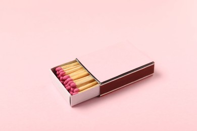 Photo of Matches in box on pink background, closeup. Mockup for design