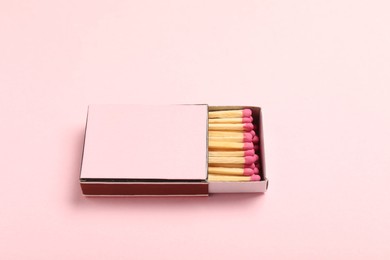 Photo of Matches in box on pink background, closeup. Mockup for design