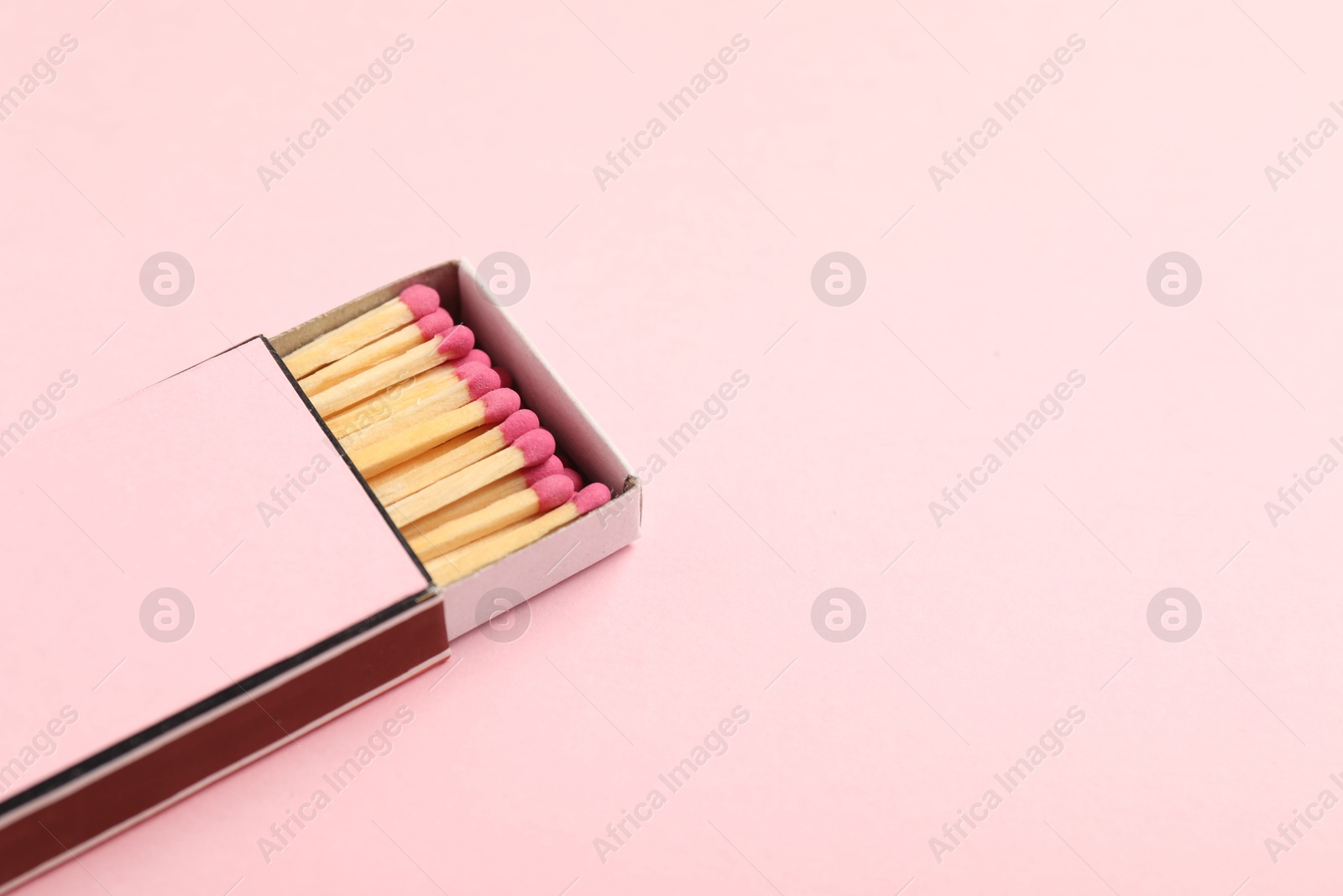 Matches in box on pink background, closeup. Mockup for design Photo of Matches in box on pink background, closeup. Mockup for design