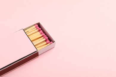 Photo of Matches in box on pink background, closeup. Mockup for design