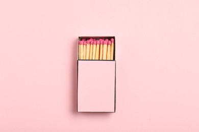 Photo of Matches in box on pink background, top view. Mockup for design