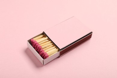 Photo of Matches in box on pink background, closeup. Mockup for design