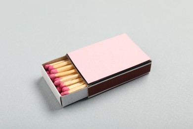 Photo of Matches in box on grey background, closeup. Mockup for design