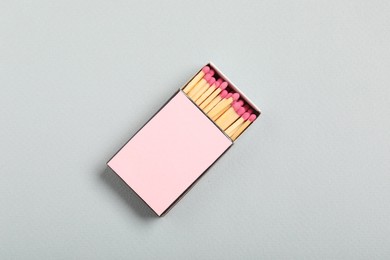 Photo of Matches in box on grey background, top view. Mockup for design