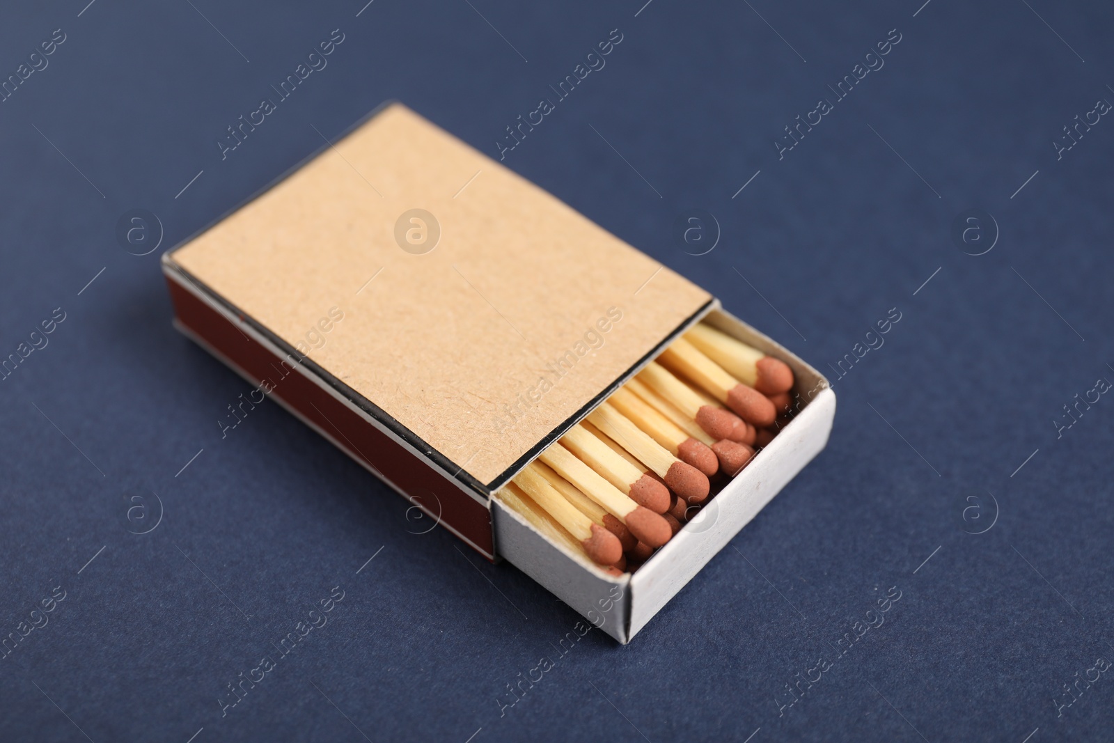 Matches in box on blue background, closeup. Mockup for design Photo of Matches in box on blue background, closeup. Mockup for design
