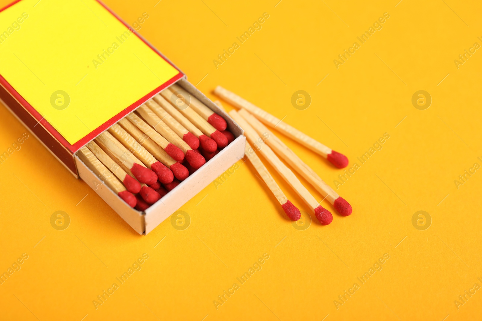 Matches and box on yellow background, closeup. Mockup for design Photo of Matches and box on yellow background, closeup. Mockup for design